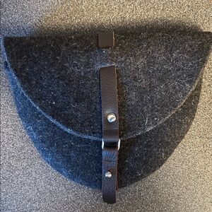 Heavy felt pouch. Hooks on to your belt.